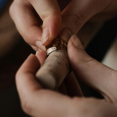 A detailed close-up of an artisan crafting a handmade ring with amber.