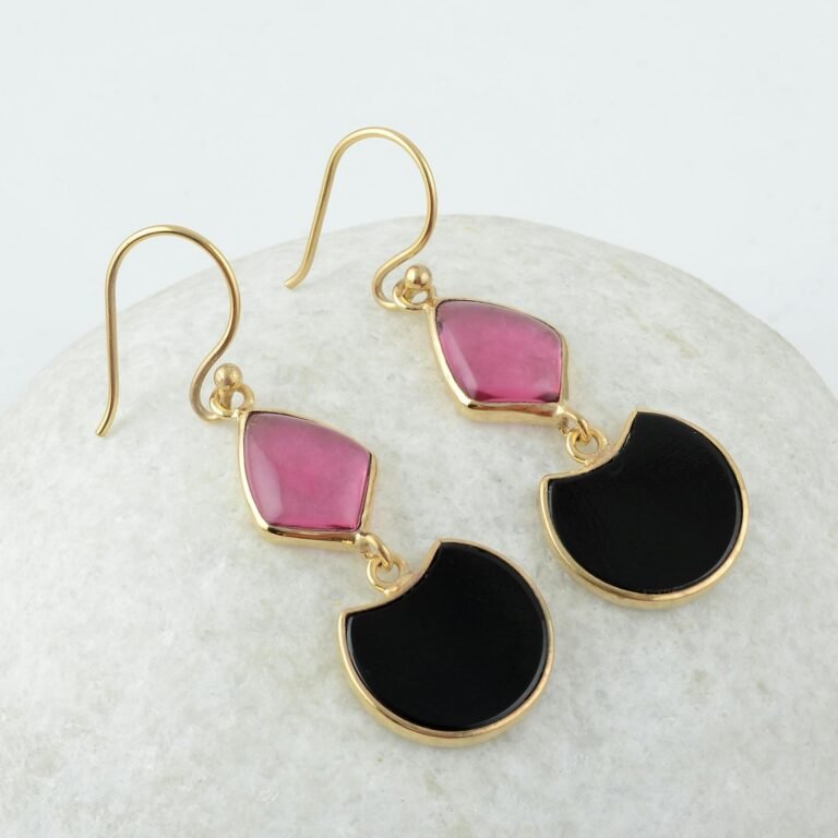 Elegant gold earrings with pink and black gemstones. Perfect for luxury fashion lovers.